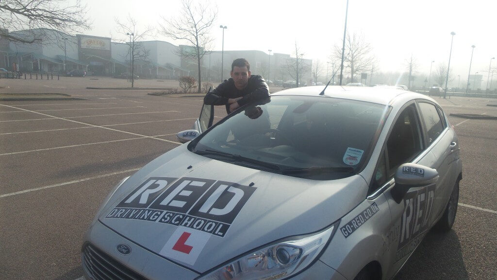 Jay Camilleri with RED driving school car
