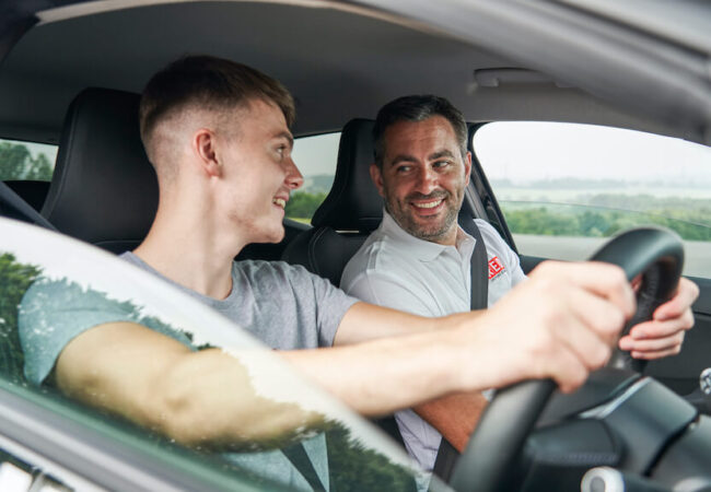 Male learner and instructor smiling