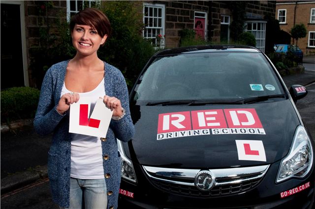 Woman tears up L PLate with RED Driving school car