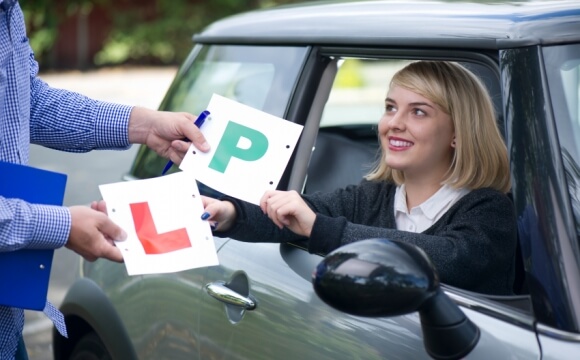 Woman swapping L Plate for P Plate
